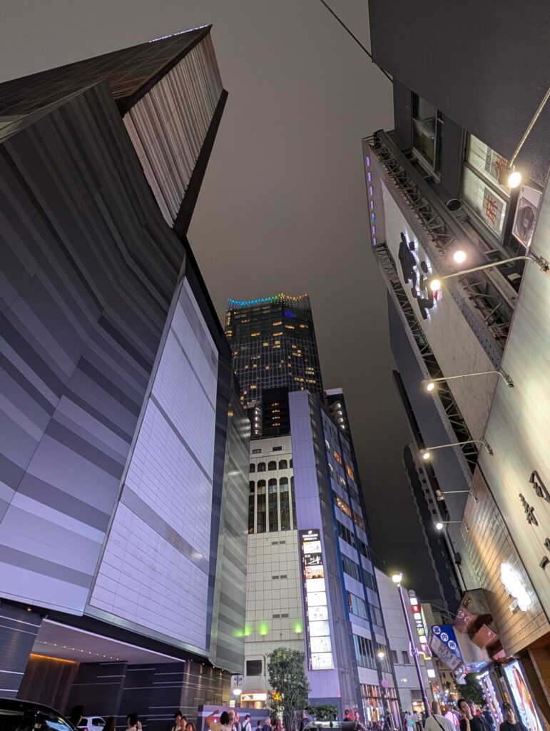 Local Secrets Edition 4: The Penthouse In The Sky. Image of the top of the Bellustar from the ground on a cloudy night with hues of purple.