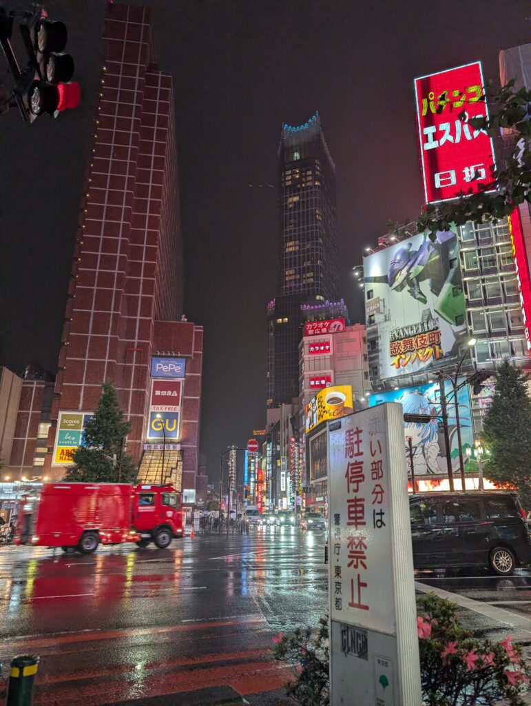 Local Secrets Edition 4: The Penthouse In The Sky. Image of the rainy streets of Shinjuku at night with the neon lights reflecting off the wet road.